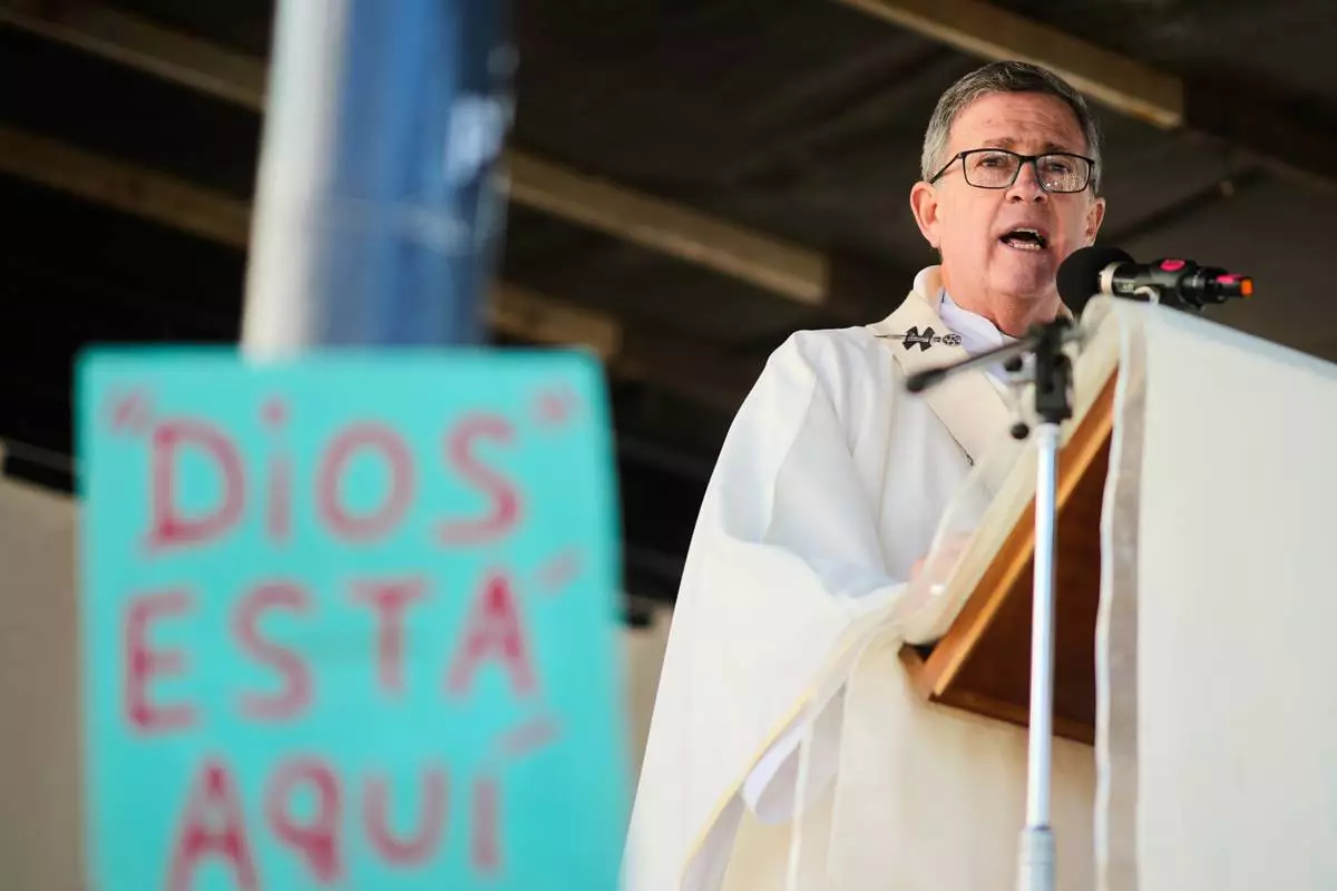 Archbishop Jorge Garcia Cuerva celebrates an outdoor Mass outside the Church of San Cayetano during the annual pilgrimage honoring Saint Cajetan, the patron saint of work, in Buenos Aires, Argentina, Friday, Aug. 7, 2026. (AP Photo/Natacha Pisarenko)