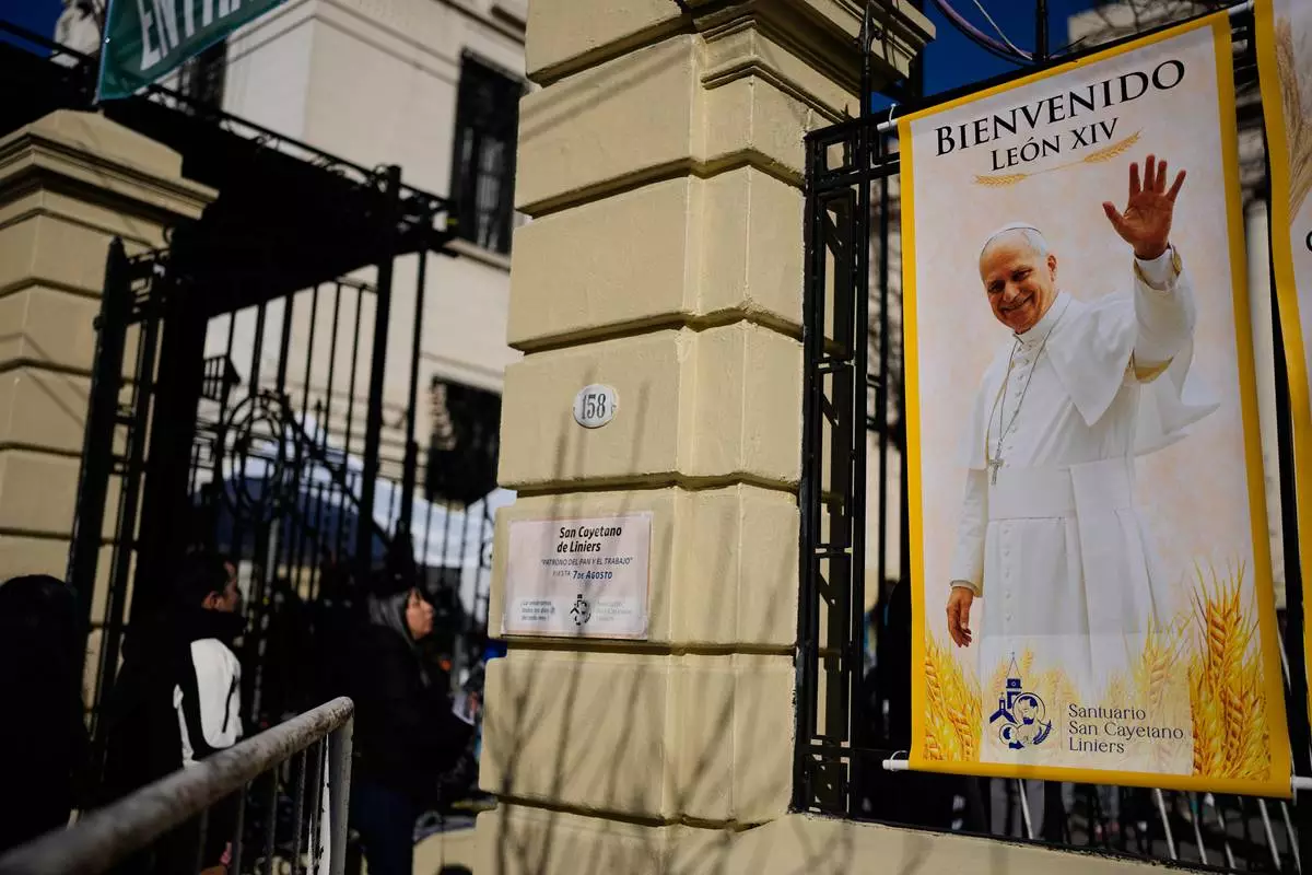 A banner of Pope Leo XIV is posted outside the Church of San Cayetano during the annual pilgrimage honoring Saint Cajetan, the patron saint of work, in Buenos Aires, Argentina, Friday, Aug. 7, 2026. (AP Photo/Natacha Pisarenko)