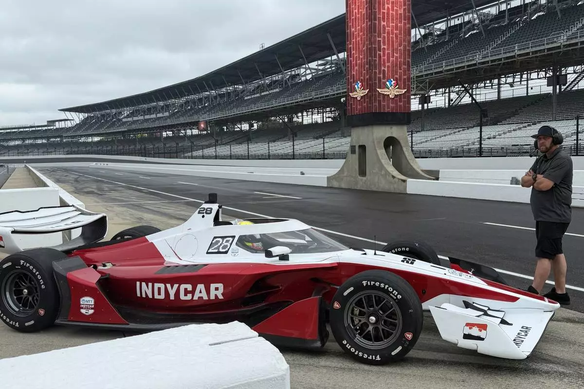 Reigning IndyCar champion Alex Palou drives into the pit lane to test a new IndyCar model, Sunday, Aug. 2, 2026, at Indianapolis Motor Speedway in Indianapolis. (AP Photo/Mike Marot)