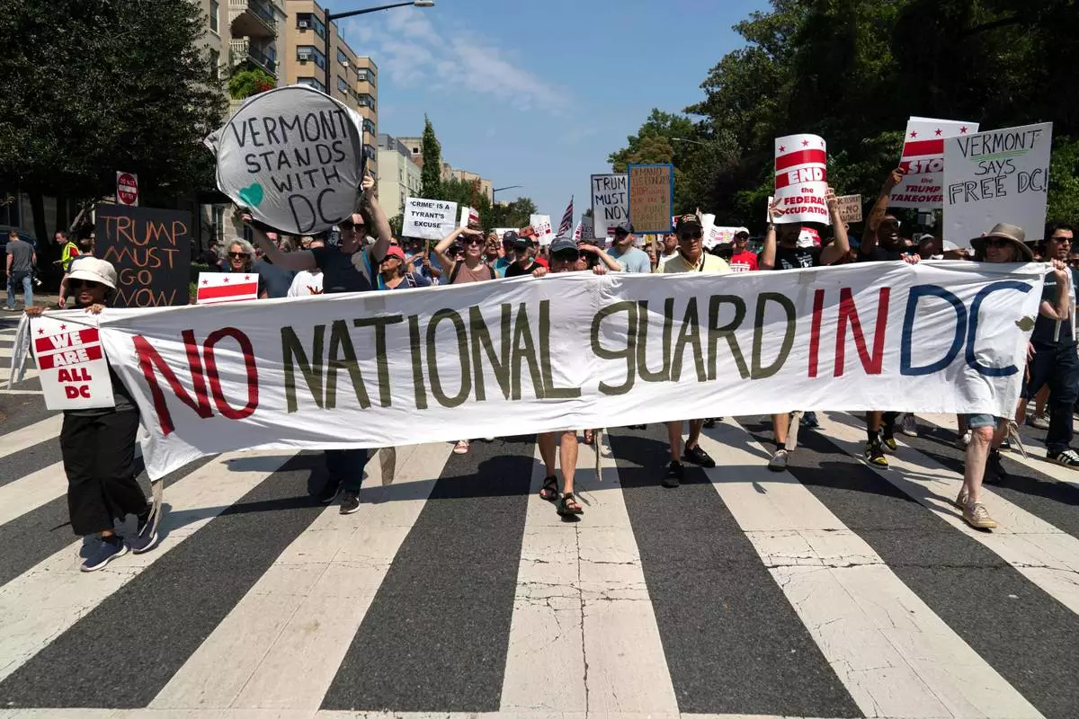 FILE - Demonstrators protest against President Donald Trump's deployment of federal law enforcement and National Guard troops during a march, Sept. 6, 2025, in Washington. (AP Photo/Jose Luis Magana, File)