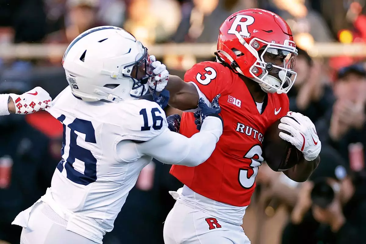 FILE - Rutgers running back Antwan Raymond (3) runs for a touchdown past Penn State safety King Mack (16) during the first half of an NCAA college football game, Nov. 29, 2025, in Piscataway, N.J. (AP Photo/Adam Hunger, File)