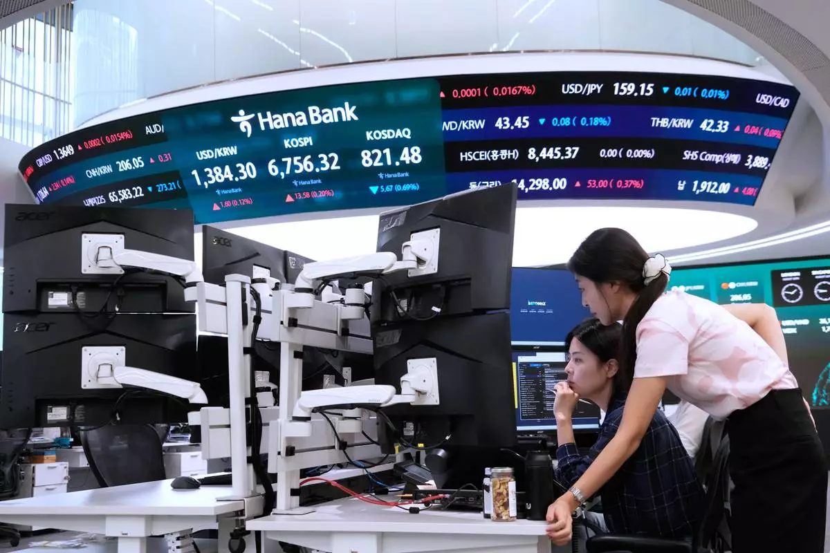 Currency traders watch monitors at the foreign exchange dealing room of the Hana Bank headquarters in Seoul, South Korea, Wednesday, Aug. 26, 2026. (AP Photo/Ahn Young-joon)