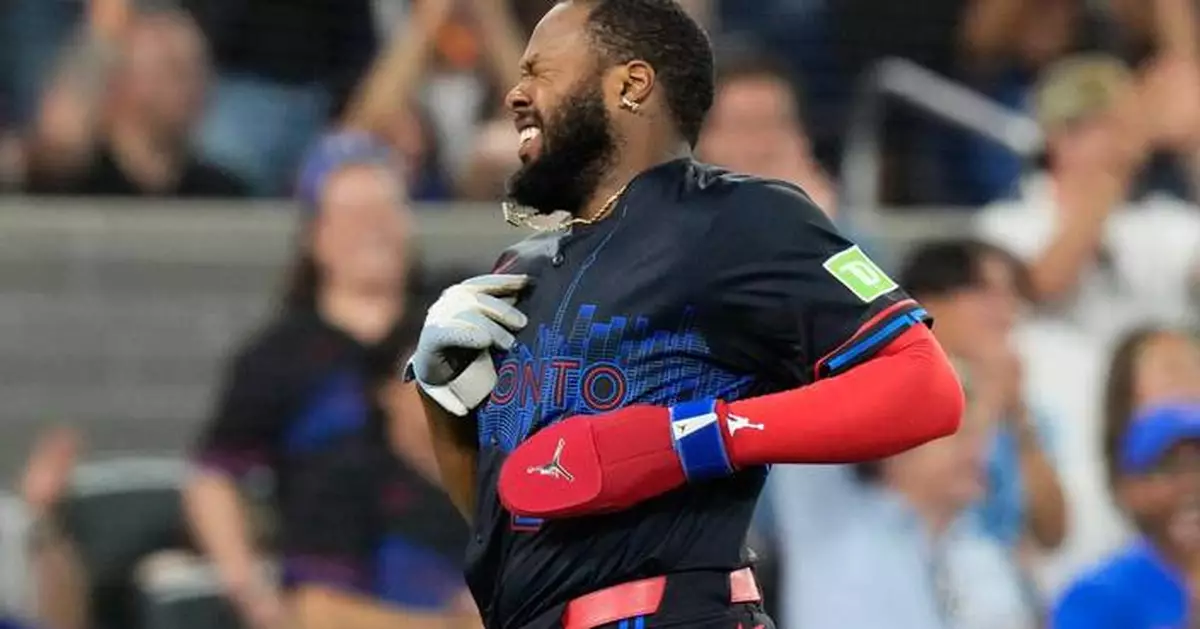 Blue Jays' Vladimir Guerrero Jr. leaves after collision with Yankees' George Lombard Jr. at third