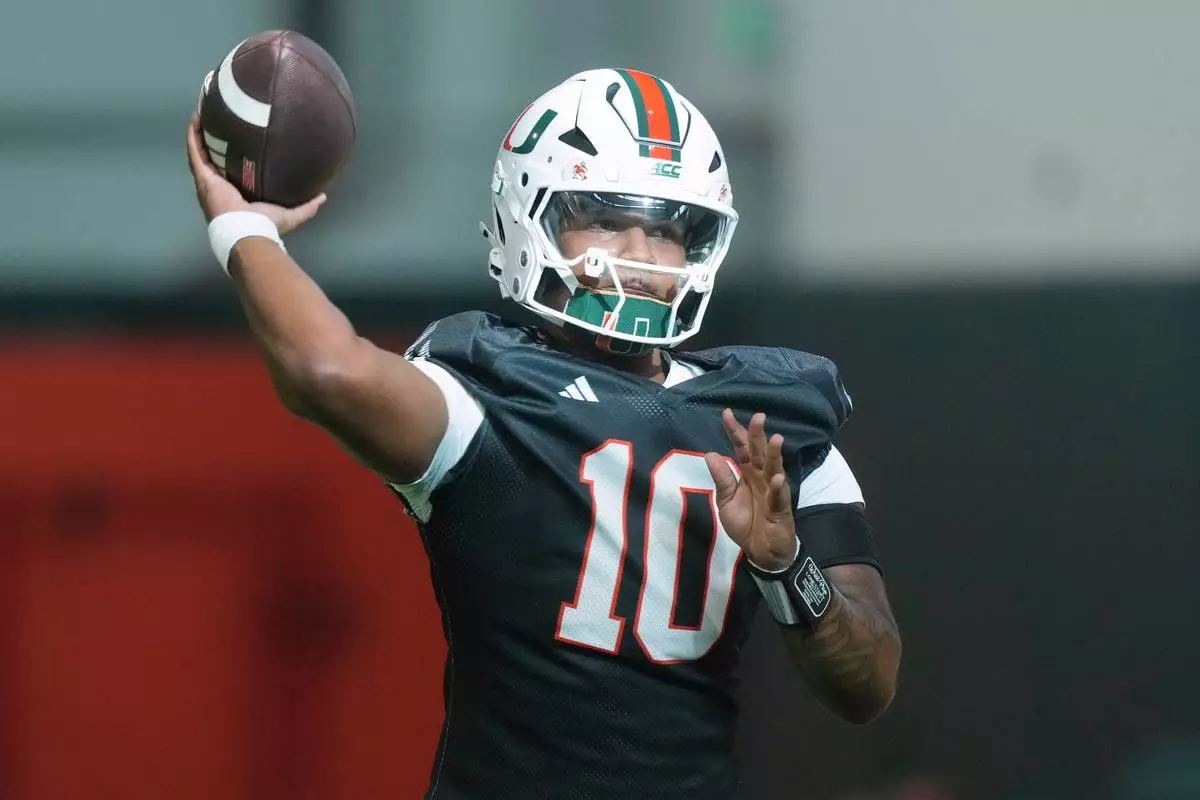 FILE - Miami quarterback Darian Mensah (10) throws a pass during a practice session at their training facility, Tuesday, Aug. 4, 2026, in Coral Gables, Fla. (AP Photo/Marta Lavandier, File)