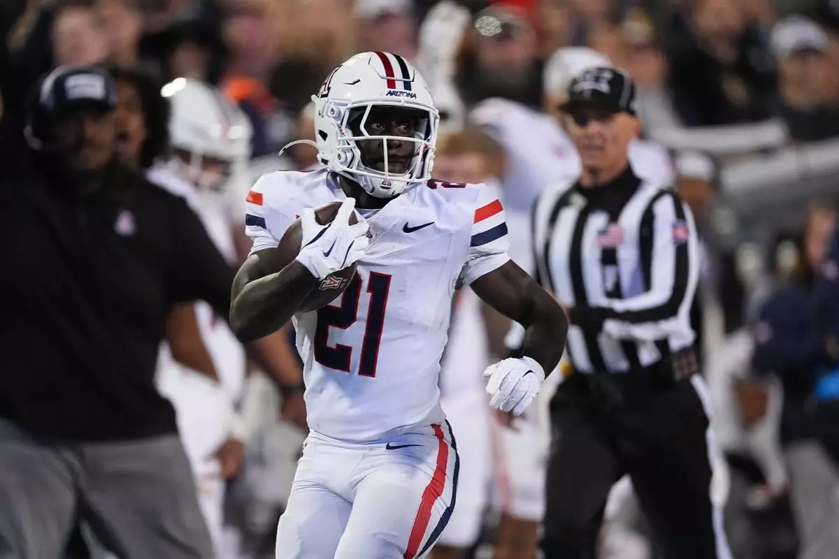 FILE - Arizona running back Ismail Mahdi (21) runs for a long gain in the second half of an NCAA college football game Saturday, Nov. 1, 2025, in Boulder, Colo. (AP Photo/David Zalubowski, File)