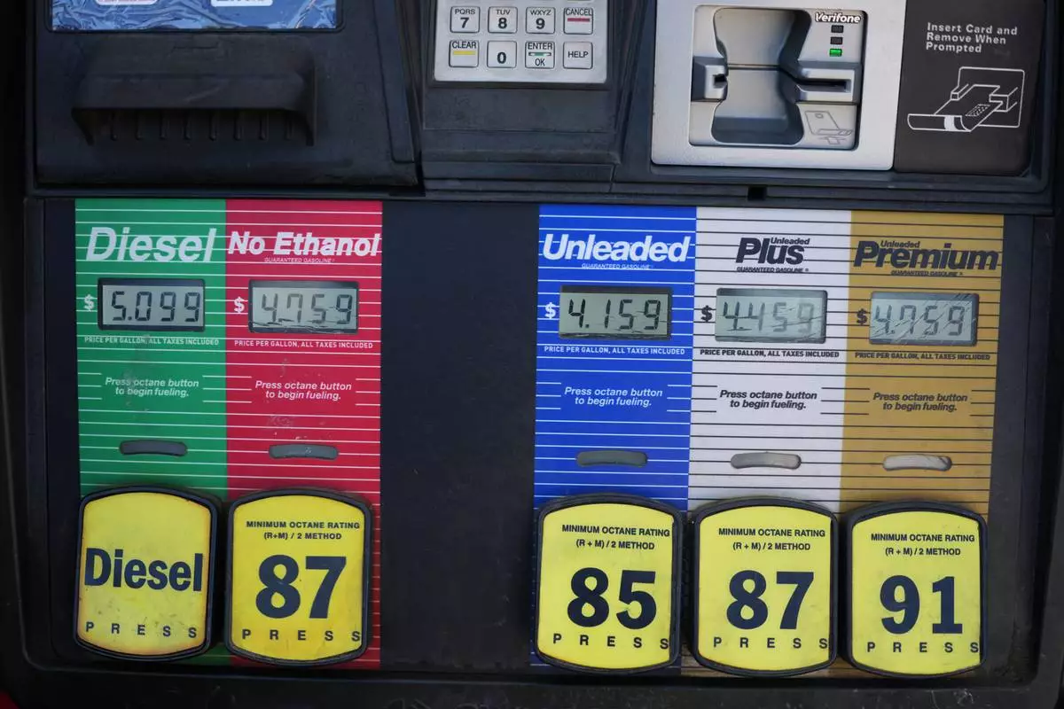 The per-gallon price is displayed electronically over the various grades of fuel available from a pump at a QT gasoline station Thursday, July 30, 2026, in Greenwood Village, Colo. (AP Photo/David Zalubowski)