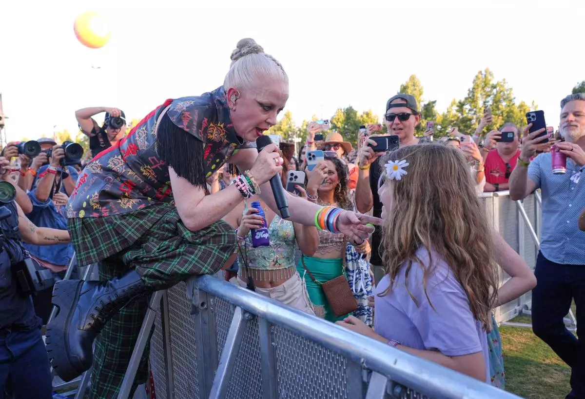 Shirley Manson of Garbage interacts with a young fan during the band's performance at the Daisy Chain Fields Music Festival on Saturday, Aug. 29, 2026, at Great Park in Irvine, Calif. (AP Photo/Chris Pizzello)