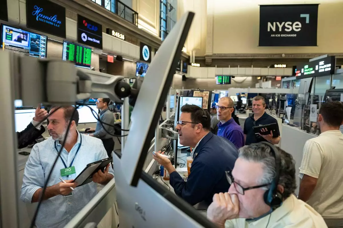 Options traders work on the floor of the New York Stock Exchange in New York, Friday, Aug. 21, 2026. (AP Photo/Yuki Iwamura)