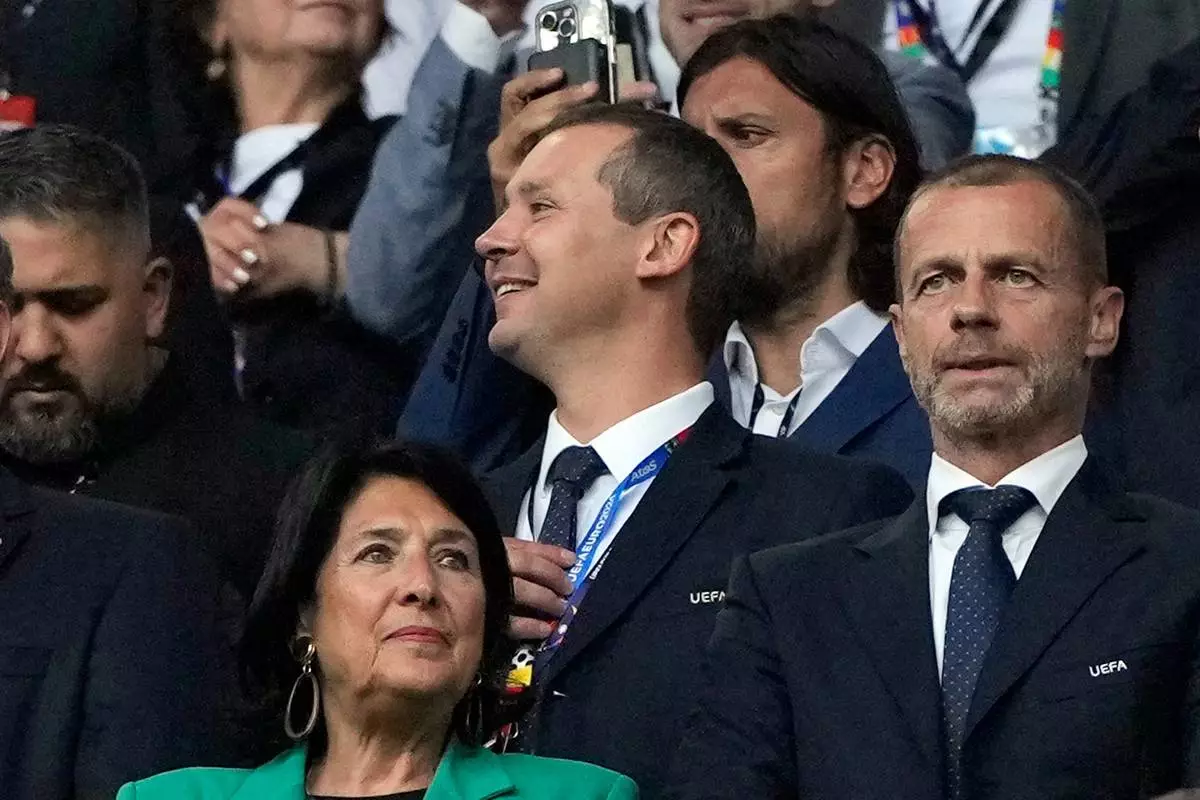 FILE - UEFA's deputy general secretary Kevin Lamour, centre, looks on as he stands next to UEFA President Aleksander Ceferin, right, prior to the start of a Group F match between Turkey and Georgia at the Euro 2024 soccer tournament in Dortmund, Germany, Tuesday, June 18, 2024. K(AP Photo/Alessandra Tarantino, File)