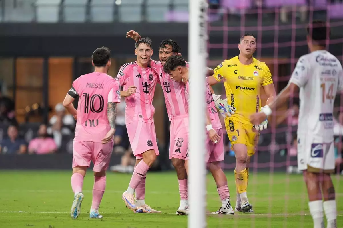 Inter Miami midfielder Telasco Segovia (8) celebrates with teammates after scoring his side's second goal past Atletico de San Luis goalkeeper Andres Sanchez (1) during the first half of a Leagues Cup soccer match, Wednesday, Aug. 5, 2026, in Miami. (AP Photo/Rebecca Blackwell)