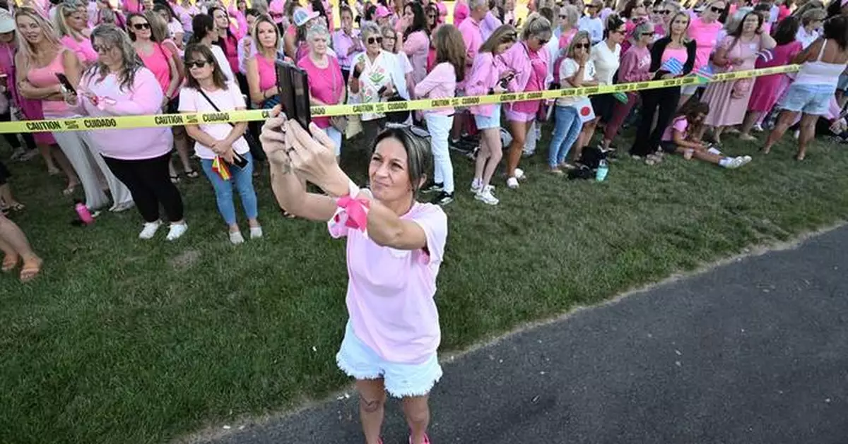 Women in pink rally in support of Lindsay Clancy who is on trial for killing 3 children