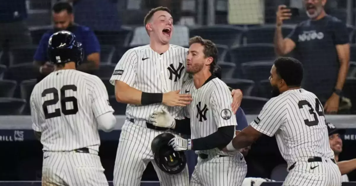 Yankees rally with 2 outs in 9th inning and beat Braves 3-2 in 10 after long rain delay