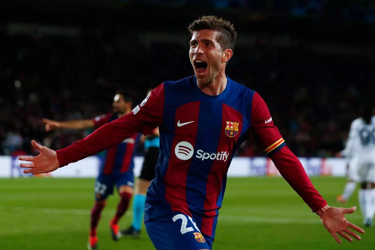 FILE - Barcelona's Sergi Roberto celebrates his sides third goal scored by Barcelona's Robert Lewandowski during the Champions League, round of 16, second leg soccer match between FC Barcelona and SSC Napoli at the Olympic Stadium in Barcelona, Spain, March 12, 2024. (AP Photo/Joan Monfort, File)