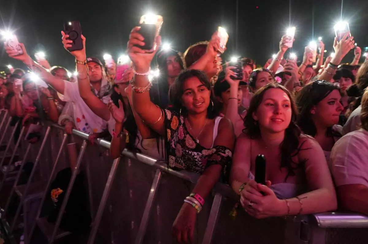 Audience members watch Olivia Rodrigo perform with special guest Sarah McLachlan at the Daisy Chain Fields Music Festival on Saturday, Aug. 29, 2026, at Great Park in Irvine, Calif. (AP Photo/Chris Pizzello)