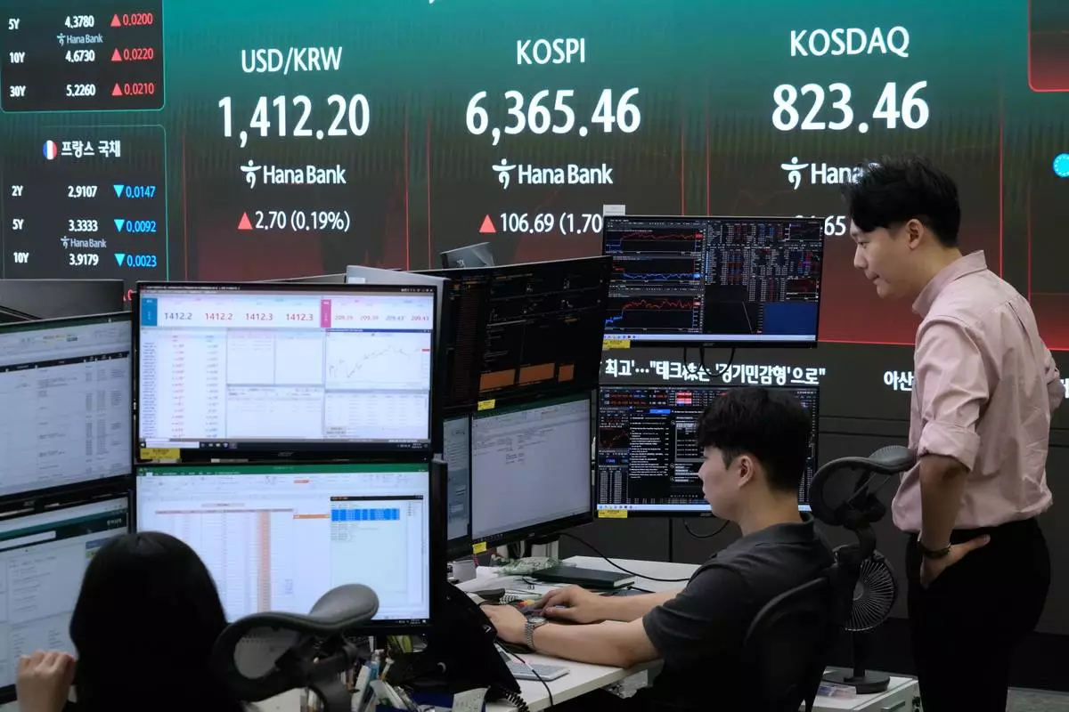 Currency traders watch monitors near a screen showing the Korea Composite Stock Price Index (KOSPI) and the foreign exchange rate between U.S. dollar and South Korean won at the foreign exchange dealing room of the Hana Bank headquarters in Seoul, South Korea, Monday, Aug. 10, 2026. (AP Photo/Ahn Young-joon)