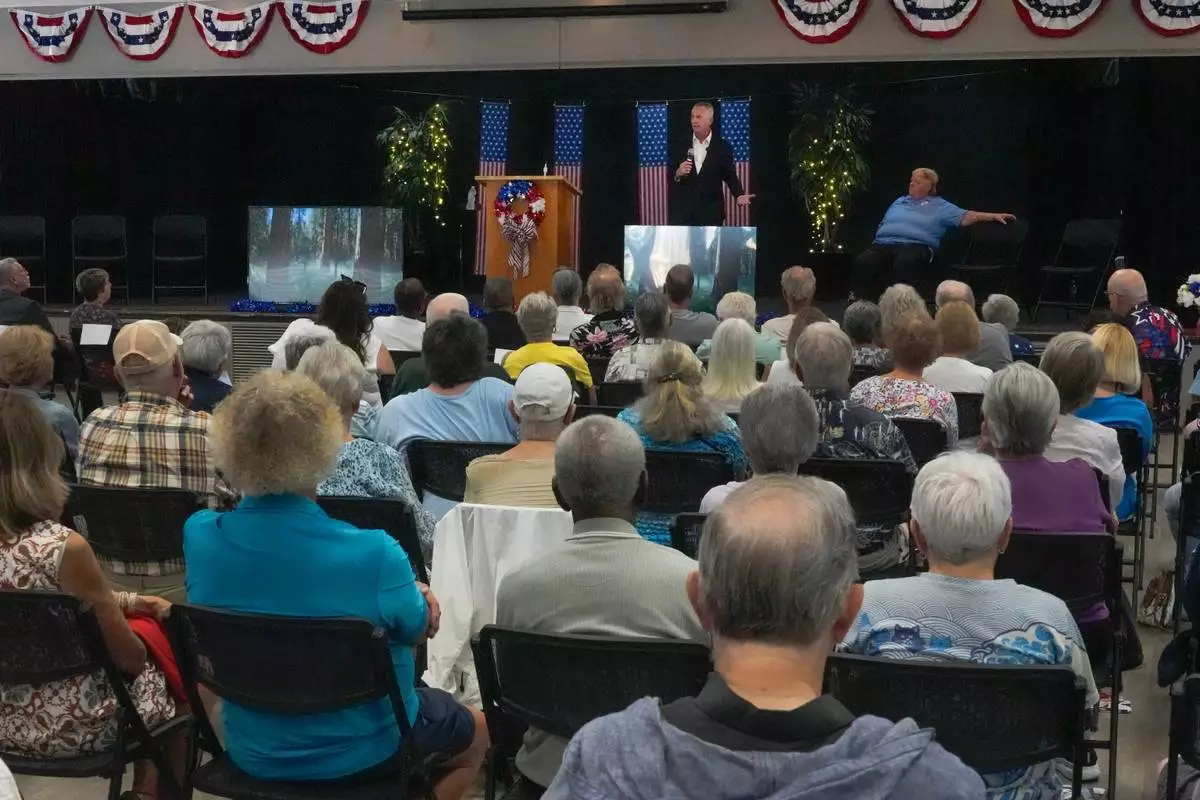 Florida Democratic gubernatorial candidate David Jolly, back center, speaks to voters during a town hall meeting, Saturday, Aug. 8, 2026, in Leesburg, Fla. (AP Photo/John Raoux)
