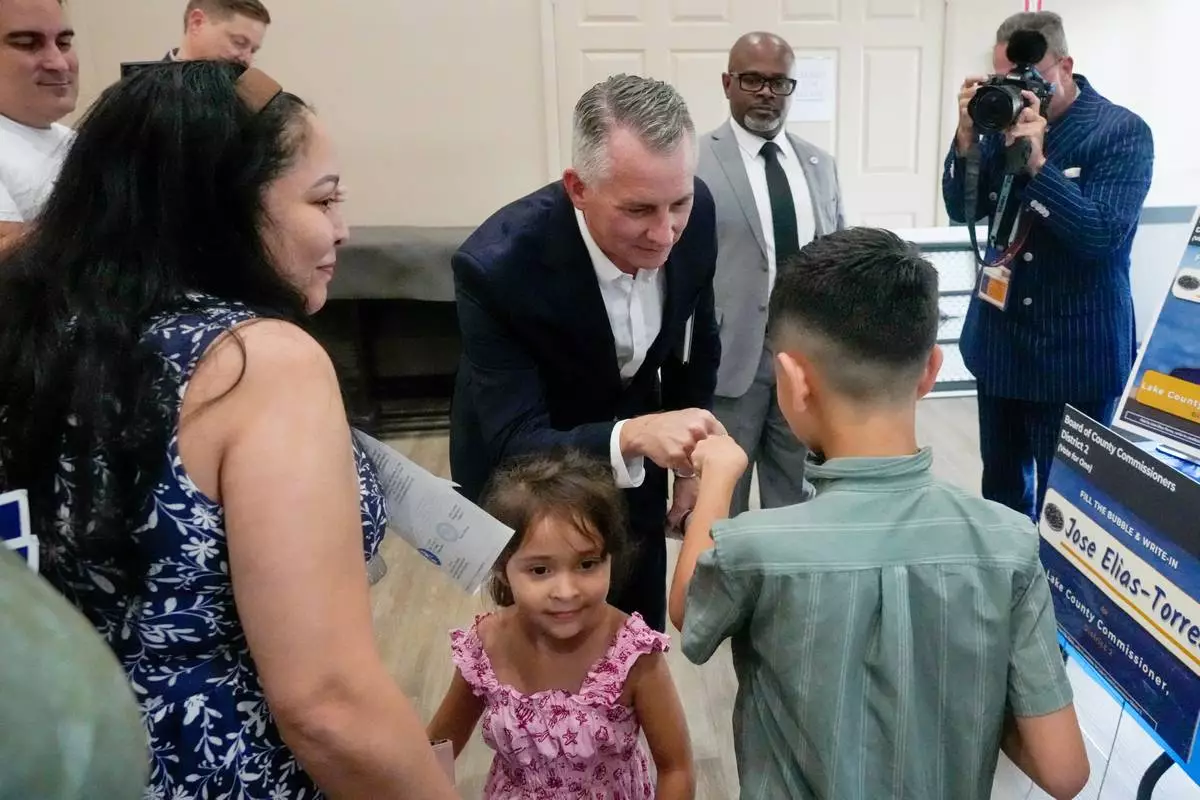 Florida Democratic gubernatorial candidate David Jolly, center, greets supporters after a town hall meeting, Saturday, Aug. 8, 2026, in Leesburg, Fla. (AP Photo/John Raoux)