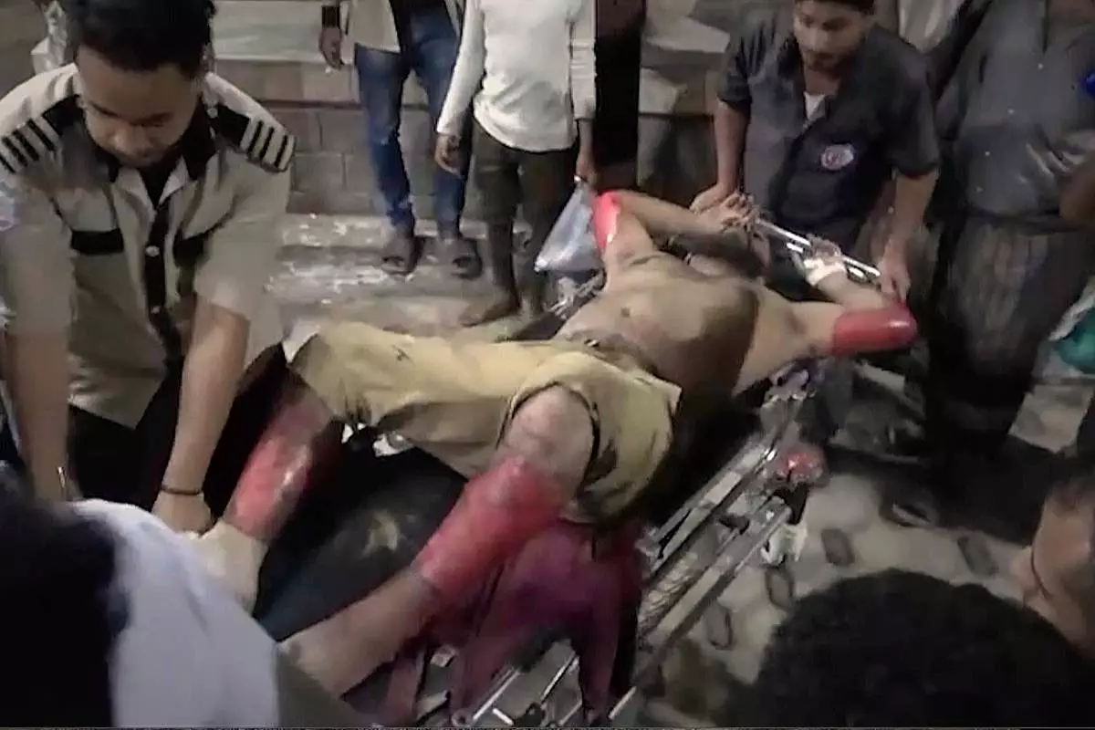 FILE - This photo taken from video released by Al Masirah TV channel shows medics carrying a wounded man into the hospital after U.S. airstrikes targeted the Ras Isa oil port held by Yemen's Houthi rebels in Hodeida, Yemen, April 18, 2025.( Al Masirah TV via AP, File)