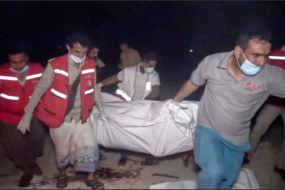 FILE - This photo taken from video released by Al Masirah TV channel shows medics carrying a dead person after U.S. airstrikes targeted the Ras Isa oil port held by Yemen's Houthi rebels in Hodeida, Yemen, April 18, 2025.( Al Masirah TV via AP, File)