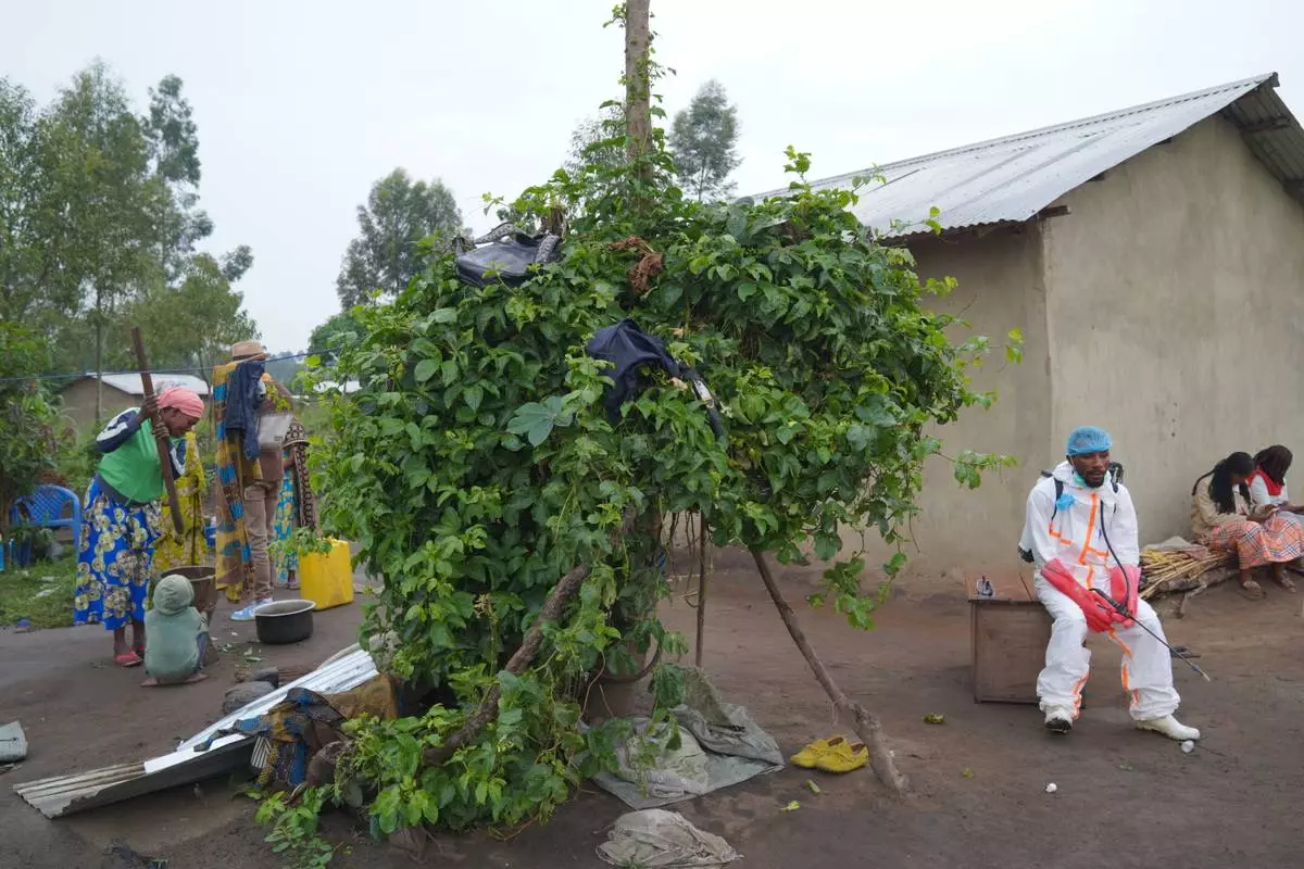 Wiza Bondele, right, a health worker on the prevention and control team, take a rest during work in Ituri province, eastern Congo, Wednesday, Aug 5, 2026. (AP Photo/Dieudonne Dirole)