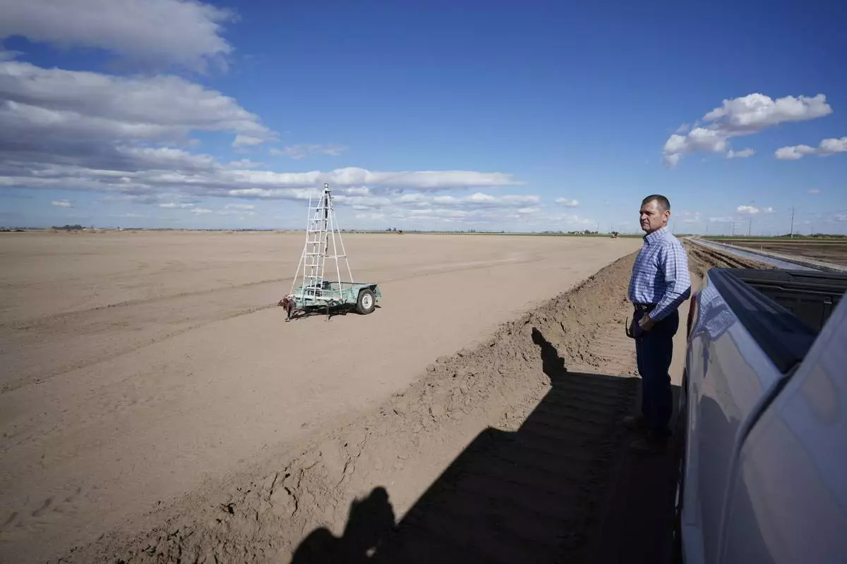 FILE - Tom Brundy looks over his field that is being prepared for planting near Calexico, Calif., Feb. 28, 2023. (AP Photo/Gregory Bull, File)