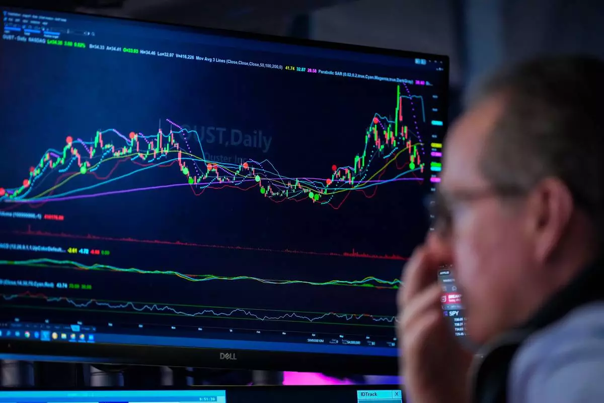A trader works on the floor of the New York Stock Exchange, Thursday, July 30, 2026, in New York. (AP Photo/Yuki Iwamura)