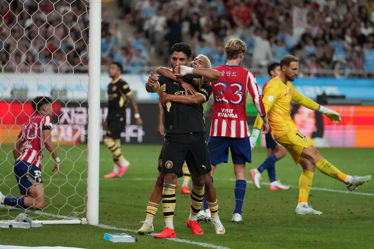 Manchester City's Omar Marmoush celebrates after scoring his side's opening goal during the preseason friendly soccer match between Manchester City and Atletico Madrid in Seoul, South Korea, Sunday, Aug. 9, 2026. (AP Photo/Lee Jin-man)