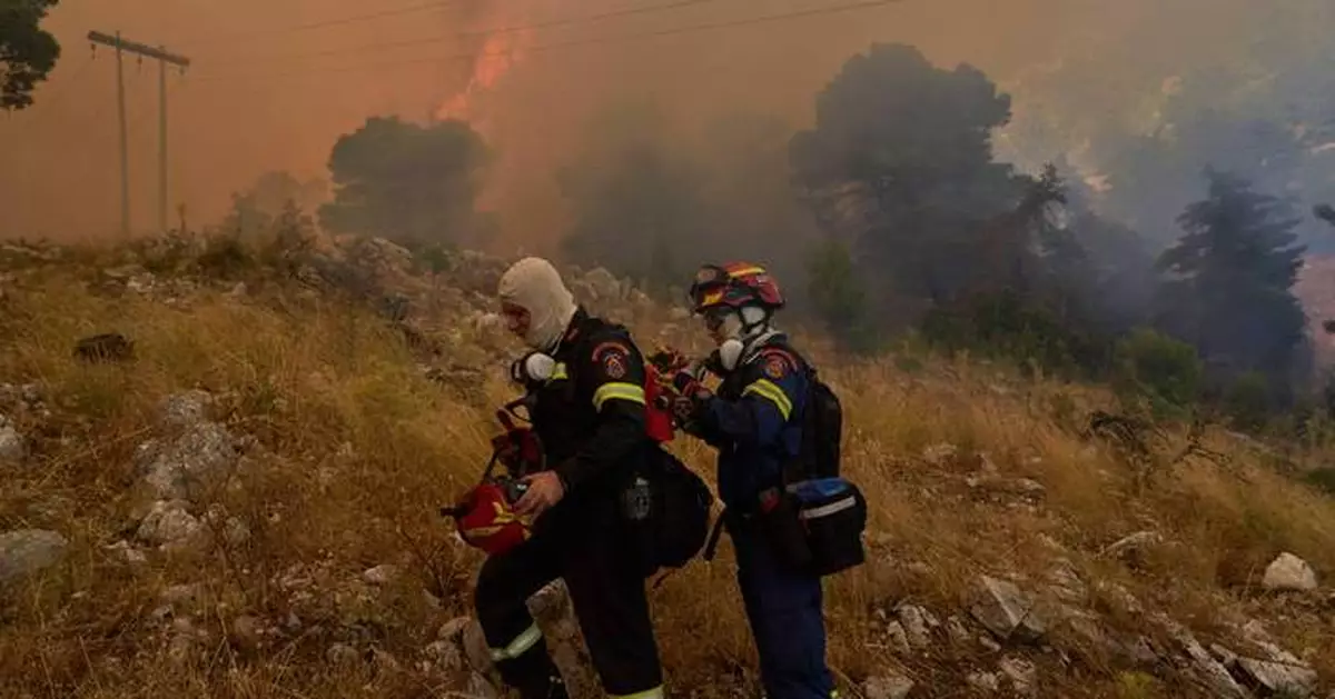 Firefighters scramble to contain fires outside Athens before winds and high temperatures return