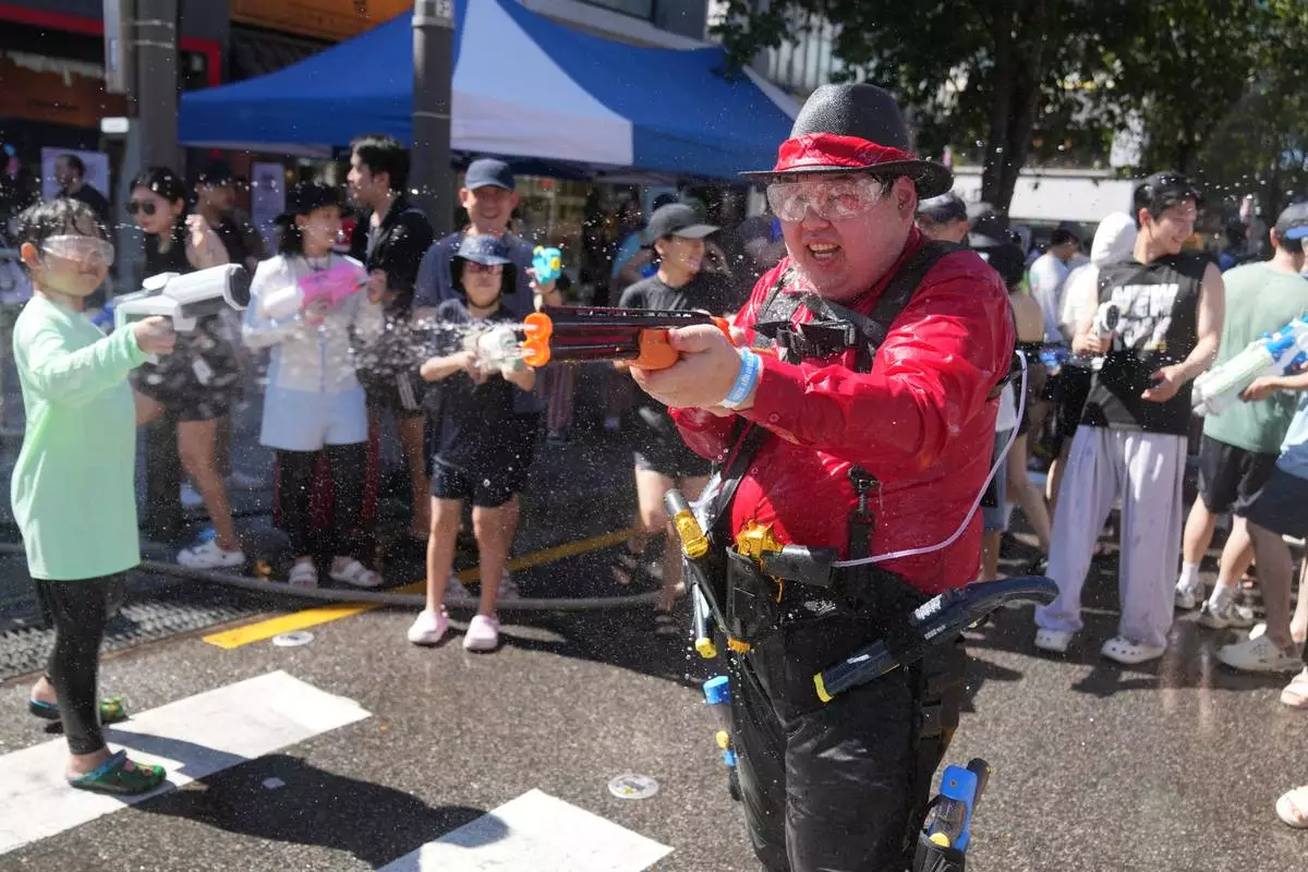 Participants spray water from their water guns during a water gun festival in Seoul, South Korea, Saturday, Aug. 8, 2026. (AP Photo/Lee Jin-man)