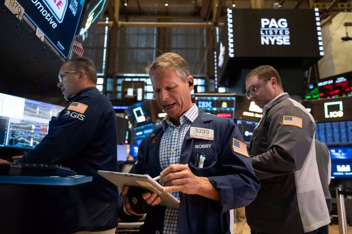 Trader Robert Charmak works on the floor of the New York Stock Exchange in New York, Friday, Aug. 21, 2026. (AP Photo/Yuki Iwamura)