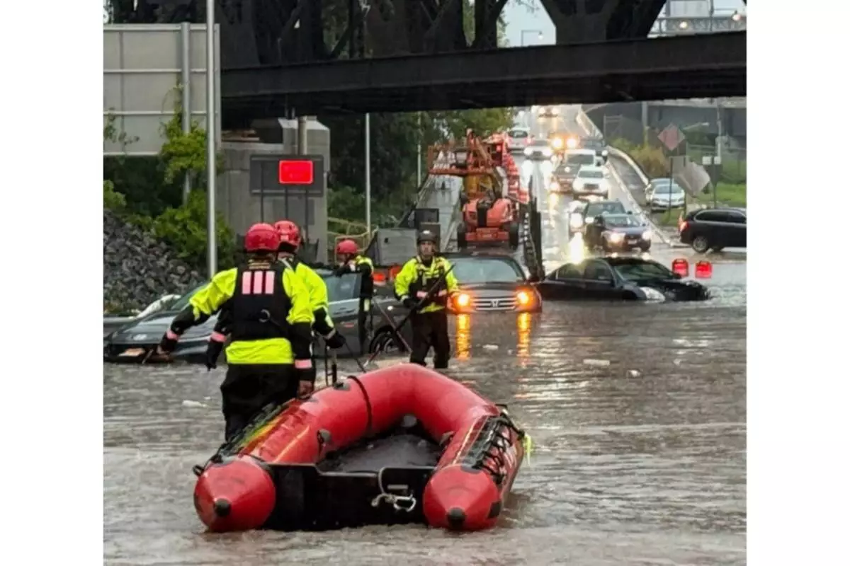 In this photo provided by the City of Jersey City, first responders try to rescue people stranded in Jersey City, N.J., Thursday, Aug. 20, 2026, after storms went through the area. (City of Jersey City via AP)