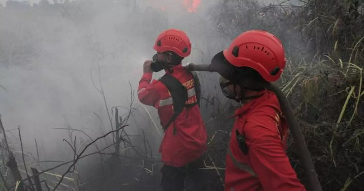 Indonesians brave choking smoke to pray for rain as country battles wildfires