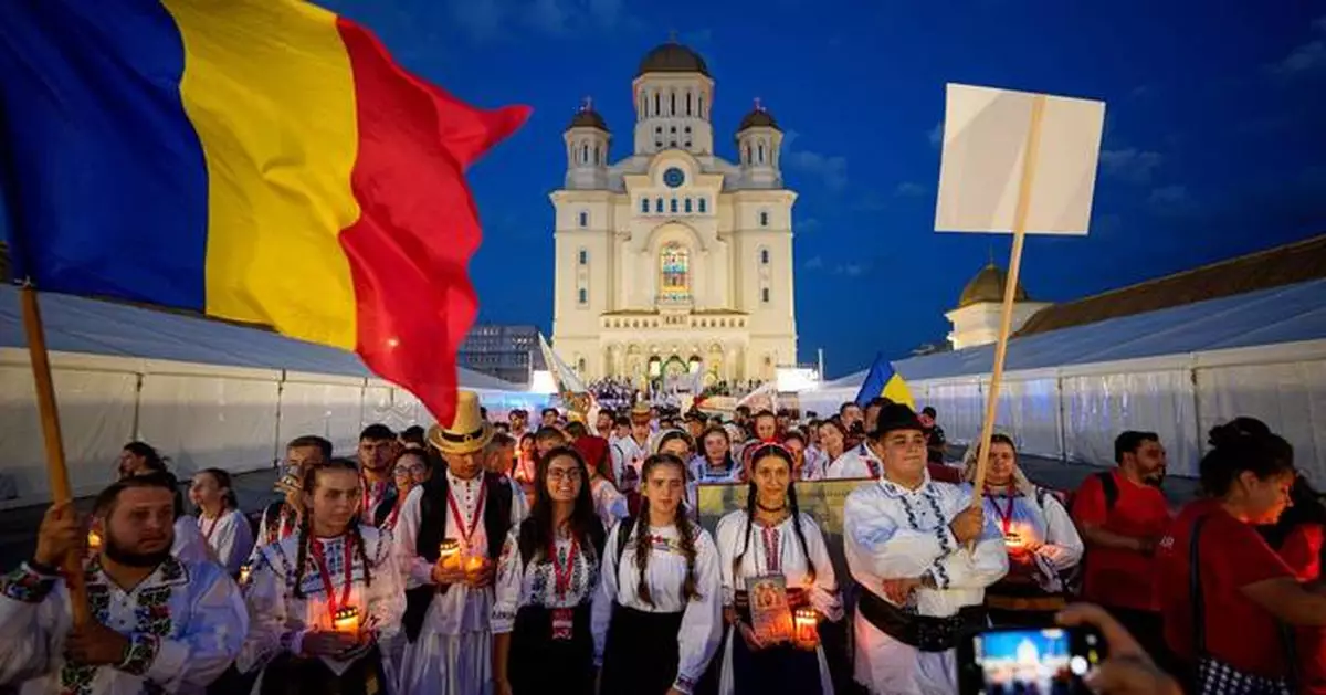 Young Orthodox Christians take part in a lights procession in Romania’s capital