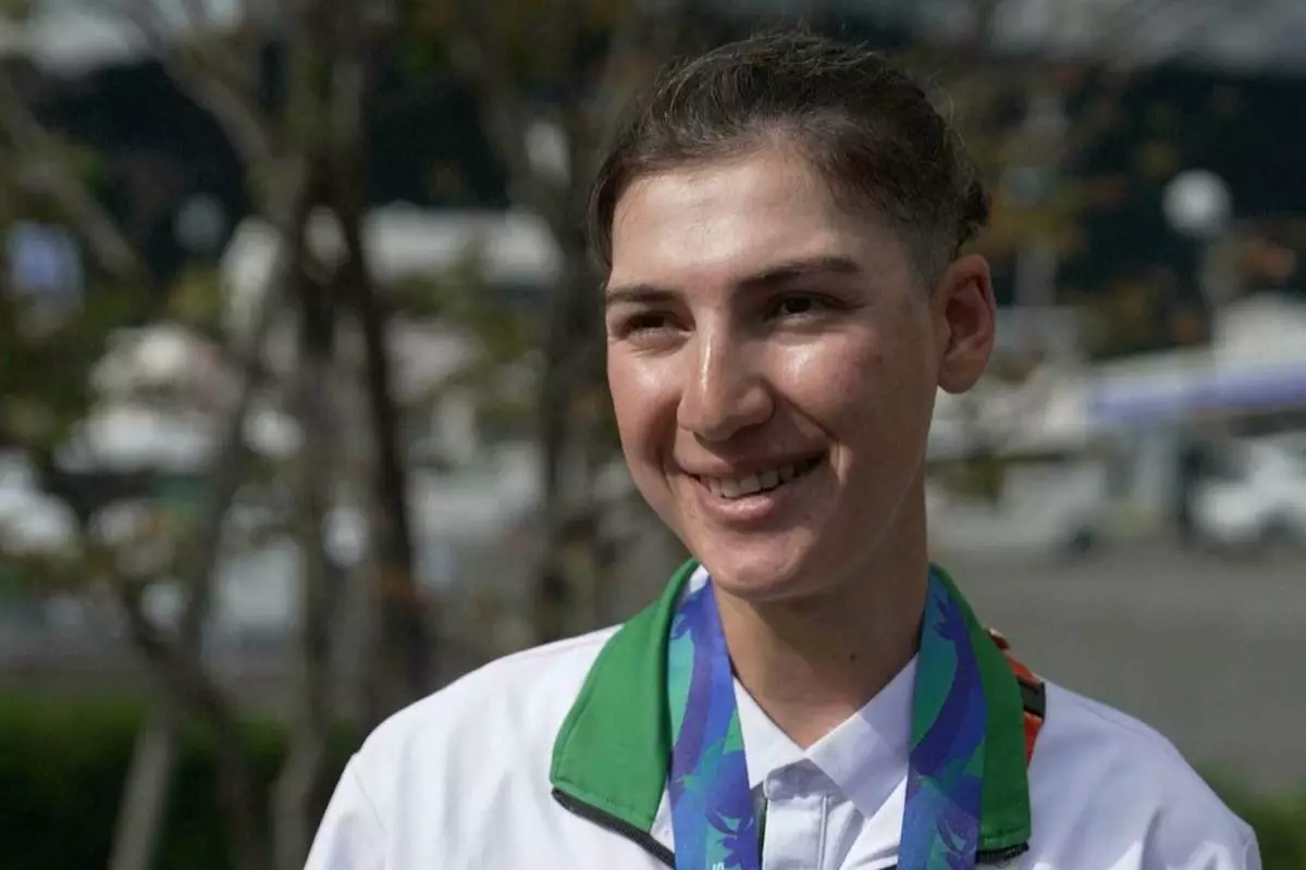 In this image made from video, Afghanistan's Fariba Hashimi, who won the Silver Medal for Women's Road Race, speaks with the Associated Press in Shinshiro, Japan, Wednesday, Sept. 23, 2026. (SNTV via AP)