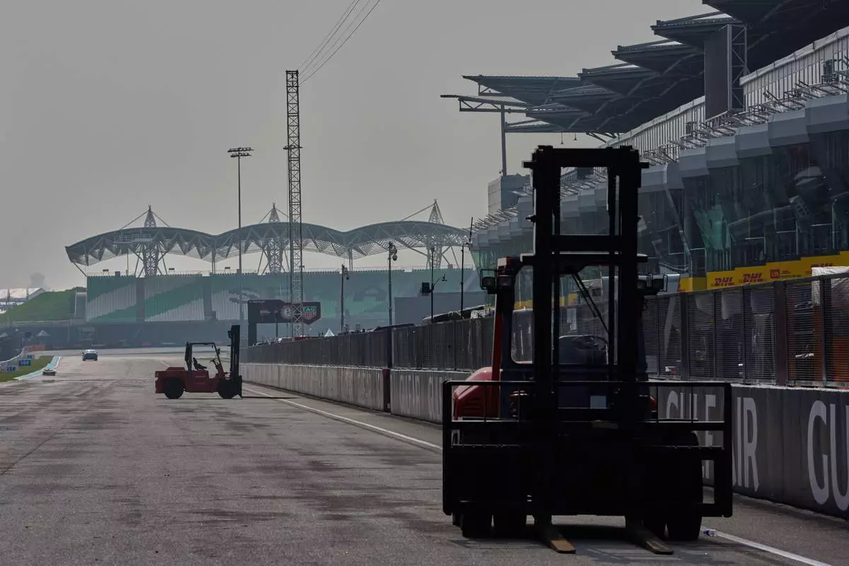 Heavy equipment is driven along the main straight during preparations for the Bahrain Grand Prix in Malaysia at the Sepang International Circuit in Sepang, Malaysia, Wednesday, Sept. 30, 2026. (AP Photo/Vincent Thian)