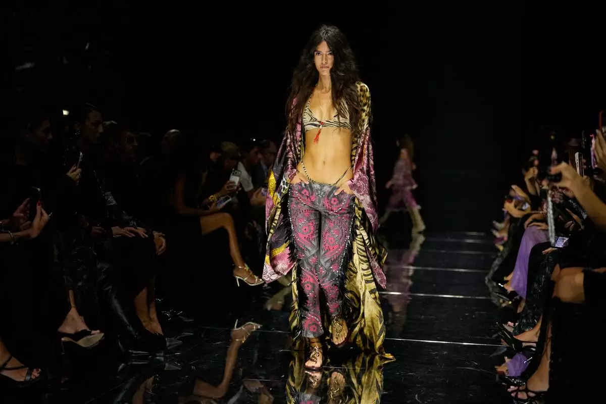 A model wears a creation part of the Roberto Cavalli women's Spring-Summer 2027 collection, presented in Milan, Italy, Thursday, Sept. 24, 2026. (AP Photo/Luca Bruno).