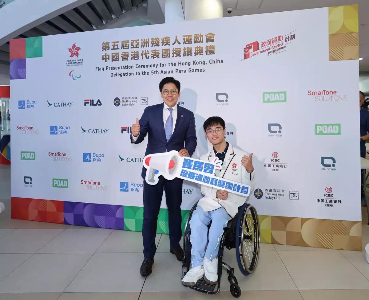 Member of the Legislative Council of the HKSAR and Steward of The Hong Kong Jockey Club The Hon Kenneth Fok (left) offers encouragement to the Hong Kong, China team ahead of the 5th Asian Para Games, including para badminton player Chow Long Ho ( right).