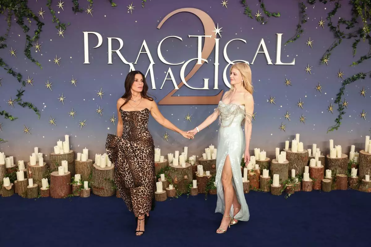 Sandra Bullock, left, and Nicole Kidman pose for photographers upon arrival at the premiere of the film 'Practical Magic 2' on Wednesday, Aug. 26, 2026, in London. (Photo by Millie Turner/Invision/AP)