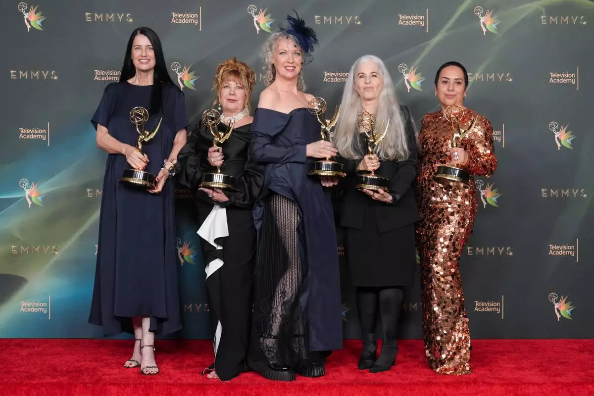 The team from "Margo's Got Money Troubles" poses in the press room with the award for outstanding contemporary makeup (non-prosthetic) during night two of the Creative Arts Emmy Awards on Sunday, Sept. 6, 2026, in Los Angeles. (AP Photo/Chris Pizzello)