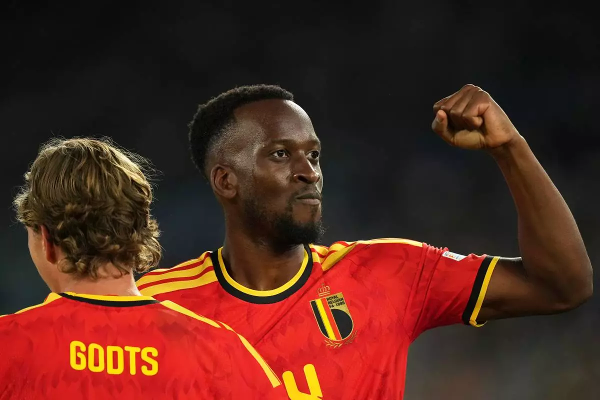 Belgium's Dodi Lukebakio celebrates with Mika Godts, left, after scoring his side's second goal during the Nations League soccer match between Italy and Belgium in Rome, Friday, Sept. 25, 2026. (AP Photo/Andrew Medichini)