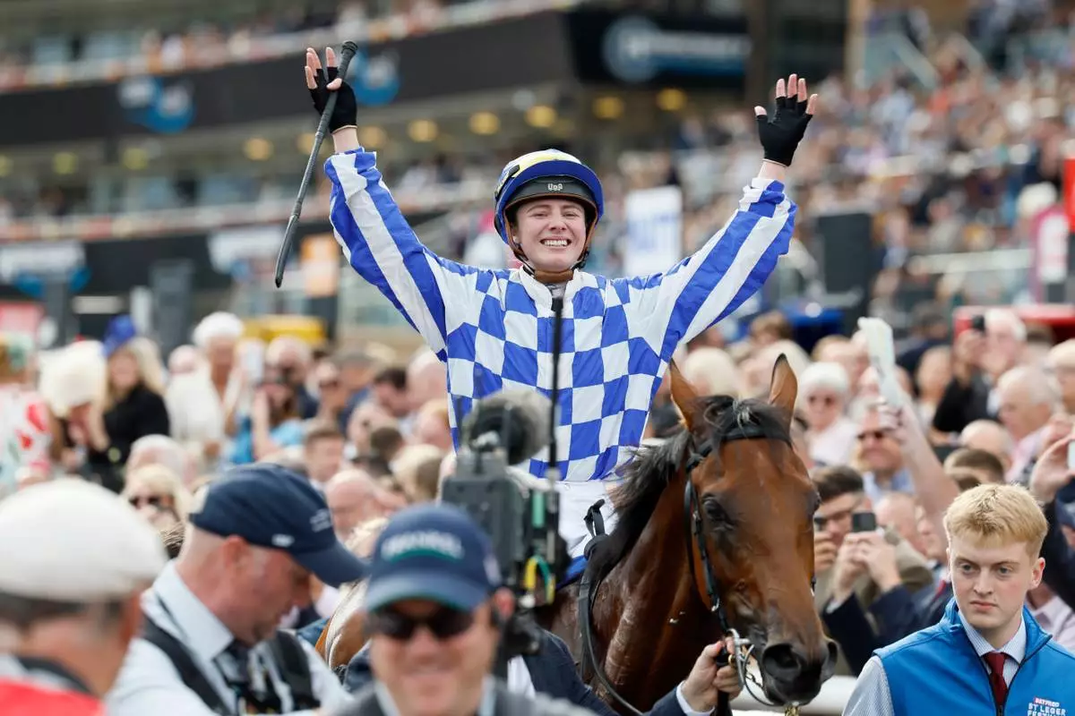 Saffie Osborne celebrates after winning the Betfred St Leger Stakes on day three of the Betfred St Leger Festival at Doncaster Racecourse in Doncaster, England, Saturday, Sept. 12, 2026. (Richard Sellers/PA via AP)