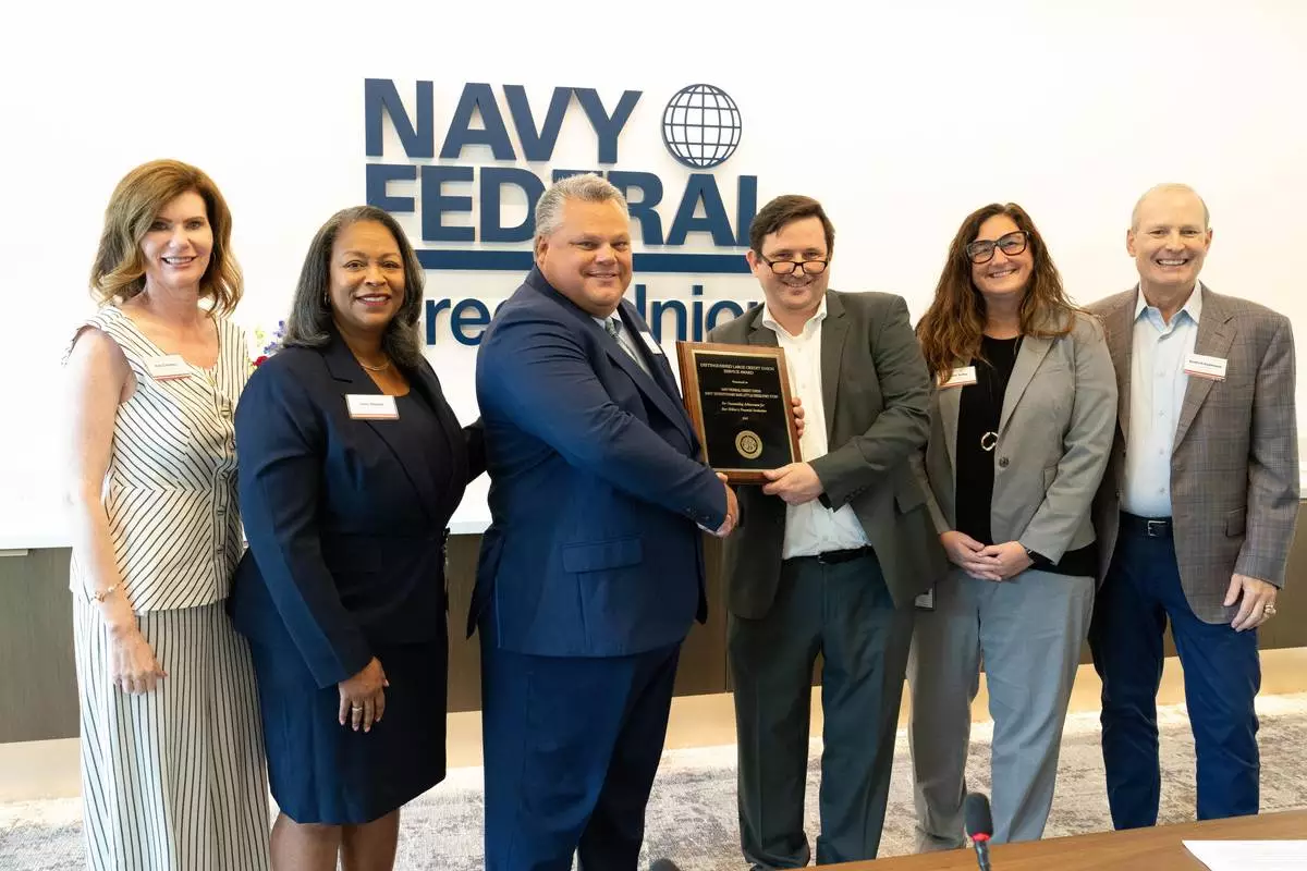 Kara Cardona and Dietrich Kuhlmann present the DON Credit Union of the Year Award to Navy Federal's Joint Expeditionary Base Little Creek-Fort Story Branch in recognition of its exemplary service to military members and their families.
