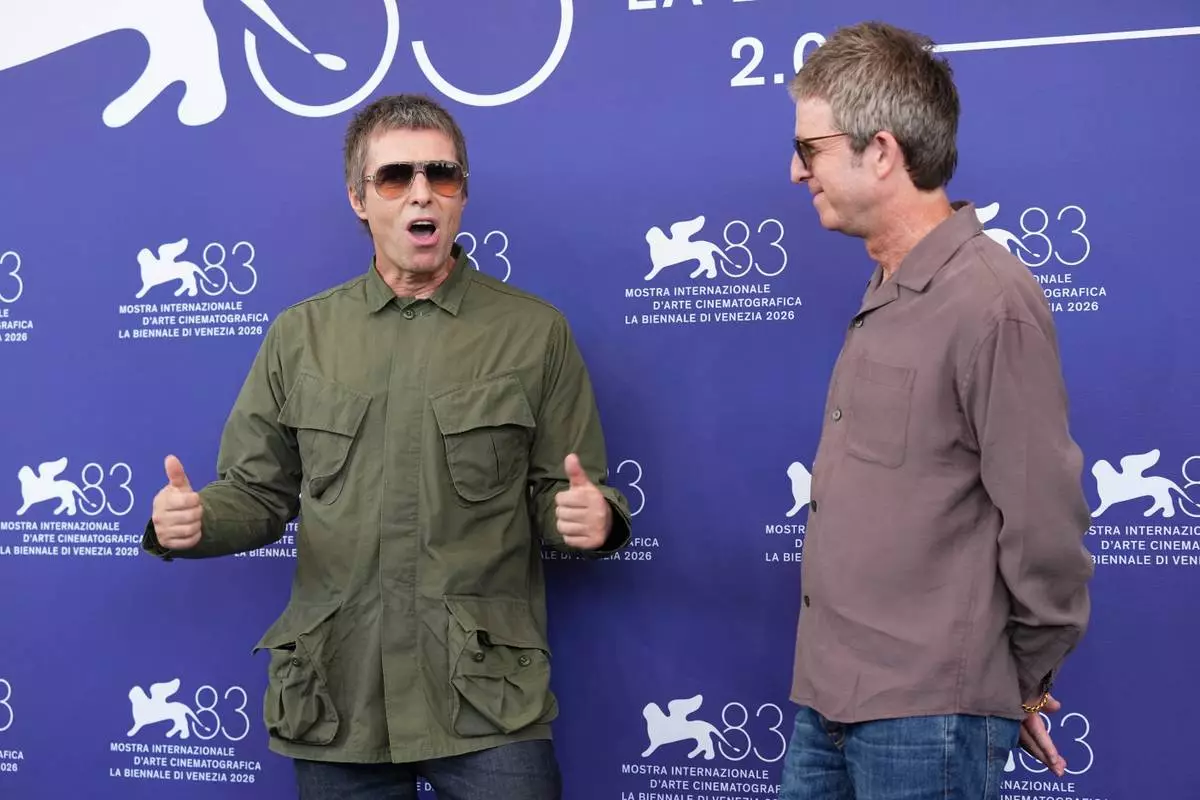 Liam Gallagher, left, and Noel Gallagher pose for photographers at the photo call for the film 'Oasis: Don't Look Back In Anger' during the 83rd edition of the Venice Film Festival in Venice, Italy, on Saturday, Sept. 5, 2026. (Photo by Scott A Garfitt/Invision/AP)