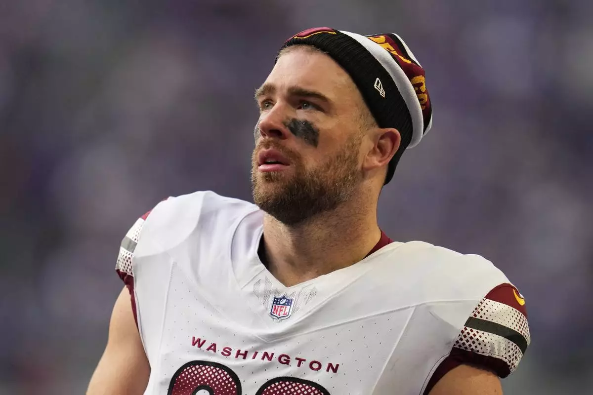 FILE - Washington Commanders tight end Zach Ertz stands on the field during the first half of an NFL football game against the Minnesota Vikings, Dec. 7, 2025, in Minneapolis. (AP Photo/Abbie Parr, File)