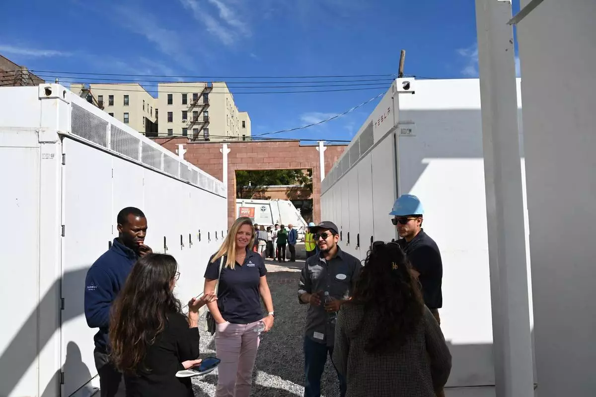 Team members and guests at NineDot’s Hunts Point battery storage site, across the street from a NYC Sanitation Dept. facility (and truck) in background.