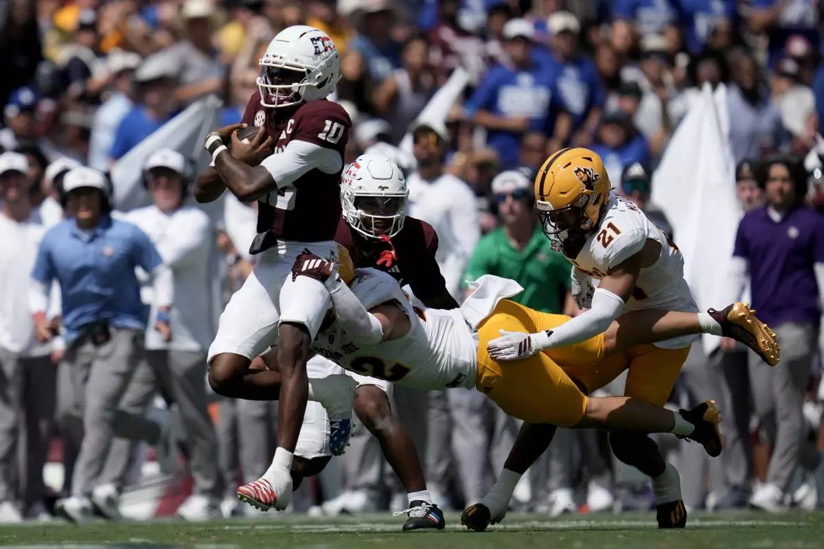 Texas A&M quarterback Marcel Reed (10) is tackeld by Arizona State linebacker Owen Long (22) after a 18 yard scramble during the second quarter of an NCAA college football game Saturday, Sept. 12, 2026, in College Station, Texas. (AP Photo/Sam Craft)