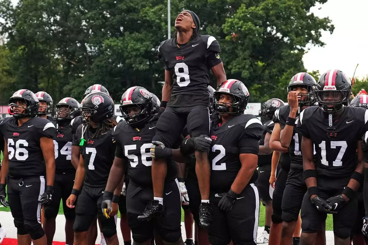 CORRECTS FIRST NAME TO AKIVA FROM AKIRA - Aliquippa Senior running back Akiva Woods (8) leads a pre-game cheer with teammates before a high school football game between Aliquippa and Mars high schools at Heinz Field in Aliquippa, Pa., Friday, Sept. 4, 2026. (AP Photo/Gene J. Puskar)