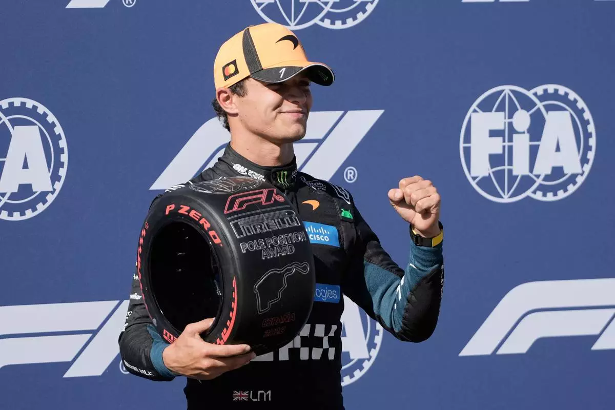 McLaren driver Lando Norris of Britain celebrates his pole position after the qualifying session for the Spanish Formula One Grand Prix in Madrid, Saturday, Sept. 12, 2026. (AP Photo/Bernat Armangue)
