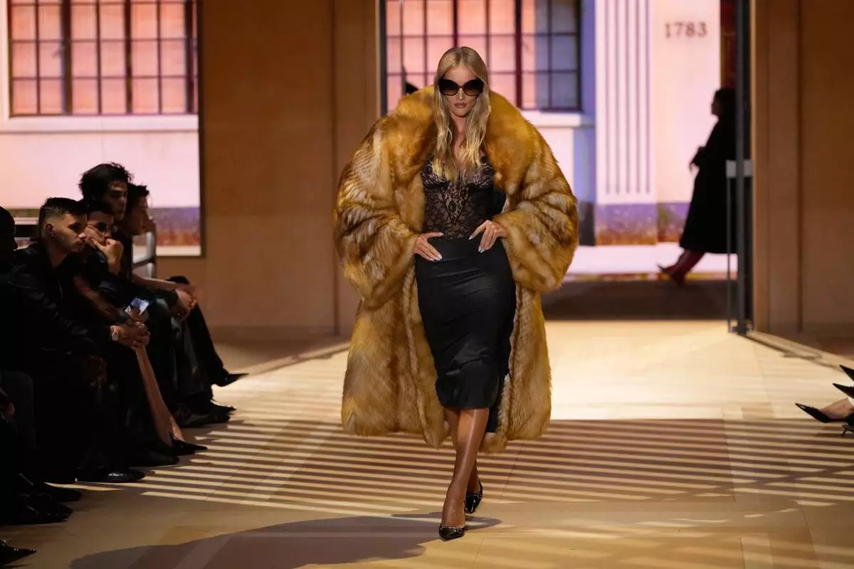 Model Rosie Huntington Whiteley wears a creation part of the Gucci women's Spring-Summer 2027 collection, presented in Milan, Italy, Friday, Sept. 25, 2026. (AP Photo/Luca Bruno)