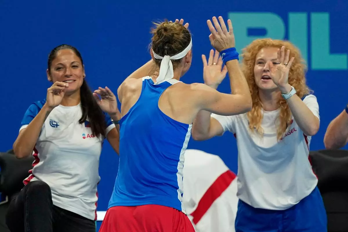 Marie Bouzkova of Czech Republic, center celebrates with her team after defeating Sonay Kartal of Britain in a quarterfinal match for the Billie Jean King Cup held in Shenzhen in southern China's Guangdong province, Tuesday, Sept. 22, 2026. (AP Photo/Andy Wong)